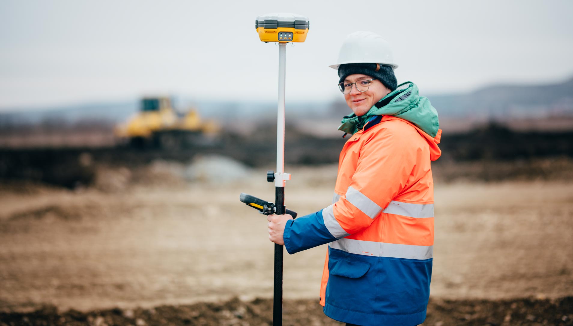 Surveyor marking property boundaries with GNSS equipment