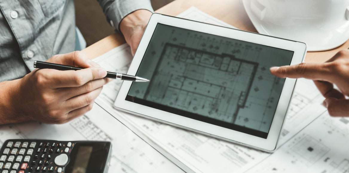 Surveyor reviewing digital building survey for UK compliance